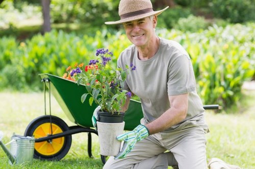 Community gardener explaining accessible planting techniques to a neighbour